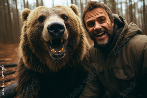 Man is posing with bear in the woods.