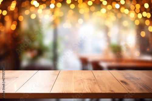 Empty textured wood table top on a background of cozy cafe interior in blur with golden lights in bokeh. Mockup, copy space, shallow depth of field, selective focus