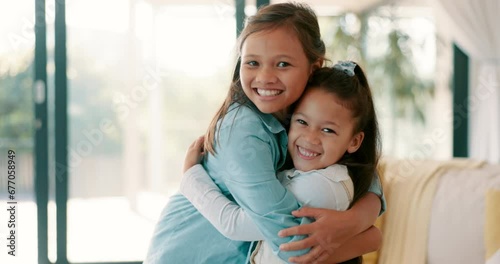 Happy little girl, hug and siblings for love, care or bonding together in living room at home. Portrait of sisters embracing childhood, unity or teamwork in happiness for youth and affection in house photo