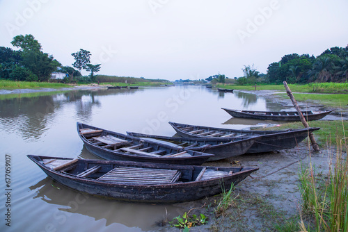 Fototapeta Naklejka Na Ścianę i Meble -  landscape view of Traditional wooden fishing boats on the shore of the Padma River in Bangladesh