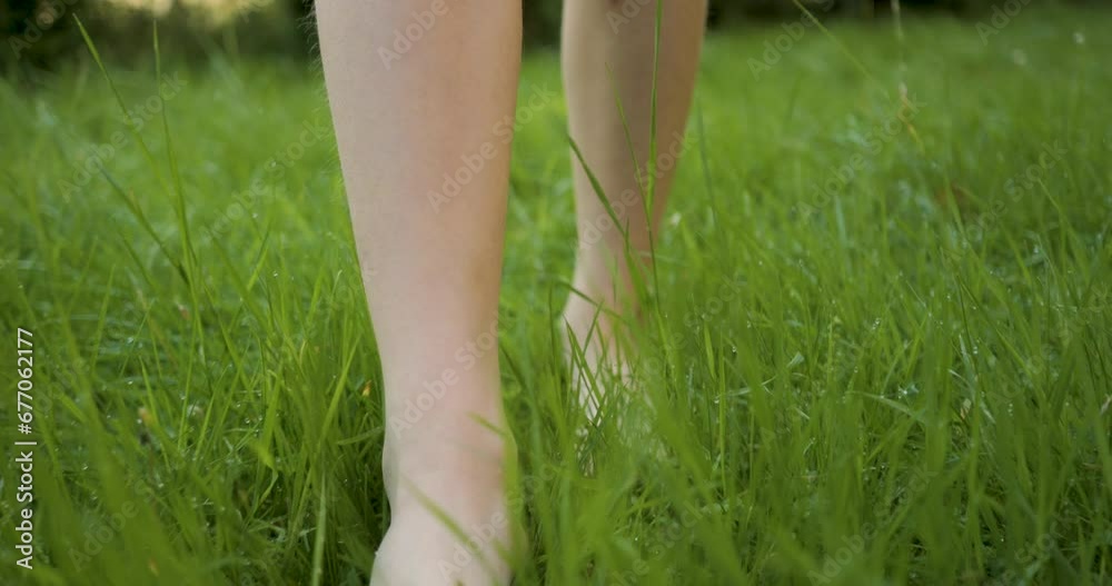 Teenager Girl Walking Bare Feet on Grass in Forest in Summer. Women's Feet Walking on Fresh Wet Grass on Garden in Summer Slow Motion. Barefoot and Healthy Care Feet. Healing Foot Massage Relax. Teenager Girl Walking Bare Feet on Grass in Forest in Summer. Women's Feet Walking on Fresh Wet Grass on Garden in Summer Slow Motion. Barefoot and Healthy Care Feet. Healing Foot Massage Relax.