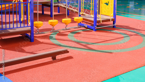 Playground climbing equipment with balance beams on colorful rubber floor in outdoors playground area at kindergarten school photo