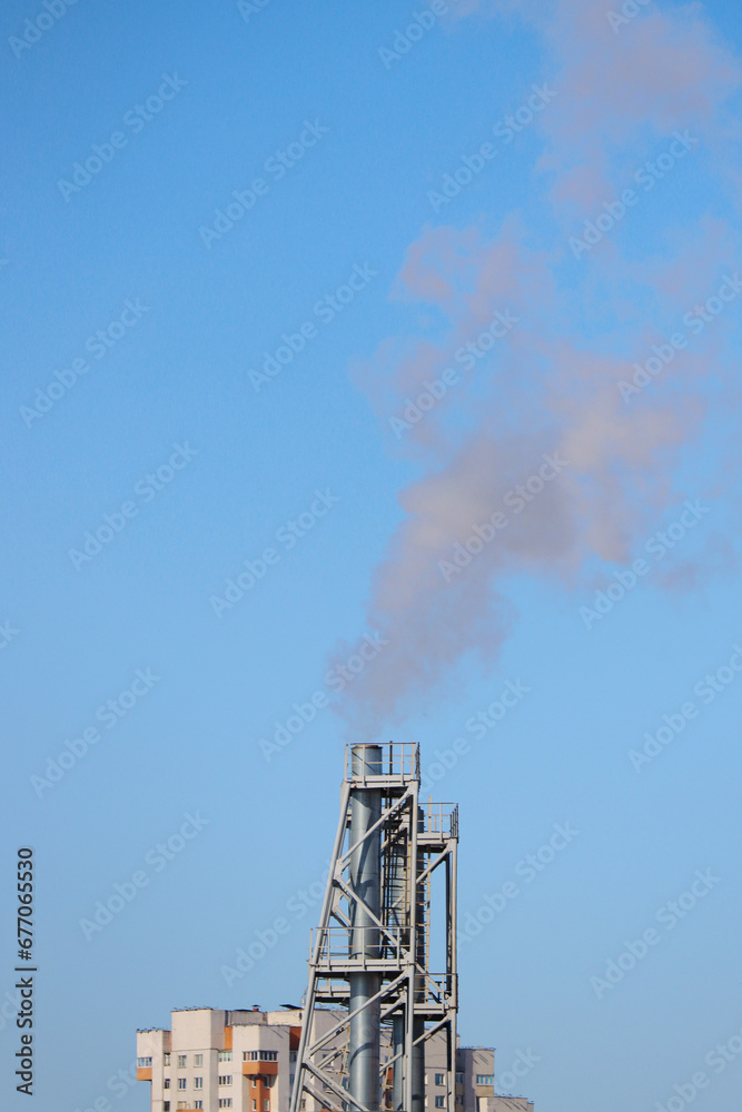 Smoking chimney of a boiler room in the city. Smoking chimney of a boiler room in the city.