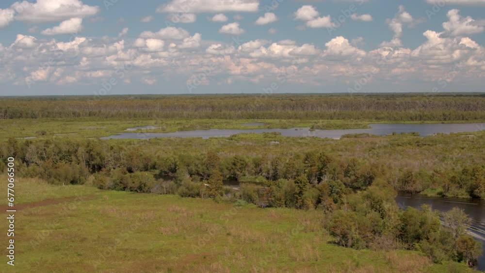 Aerial Panning Shot Of Nautical Vessel Moving In River, Drone Flying Forward Over Green Landscape On Sunny Day - Bayou, Louisiana Aerial Panning Shot Of Nautical Vessel Moving In River, Drone Flying Forward Over Green Landscape On Sunny Day - Bayou, Louisiana