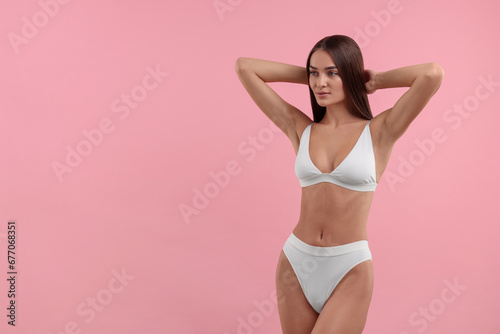 Young woman in stylish white bikini on pink background. Space for text © New Africa