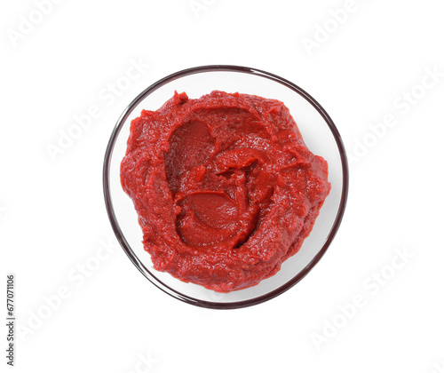 Glass bowl of tasty tomato paste isolated on white, top view