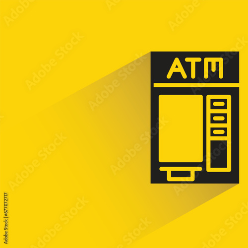 atm with shadow on yellow background