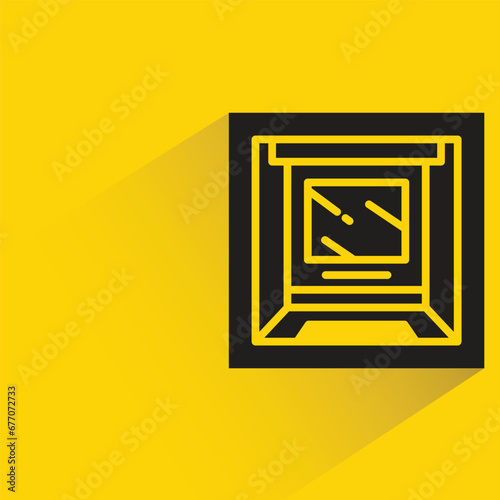 atm with shadow on yellow background