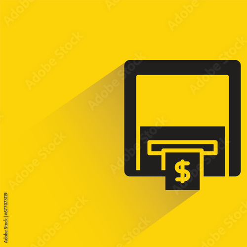 atm with shadow on yellow background