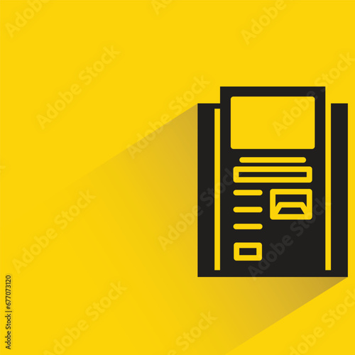 atm with shadow on yellow background