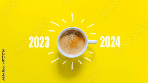 Happy new year and Merry Christmas 2024. Cup of coffee change and download 2023 to 2024 on yellow background. Start up and New Year Concept. Copy space