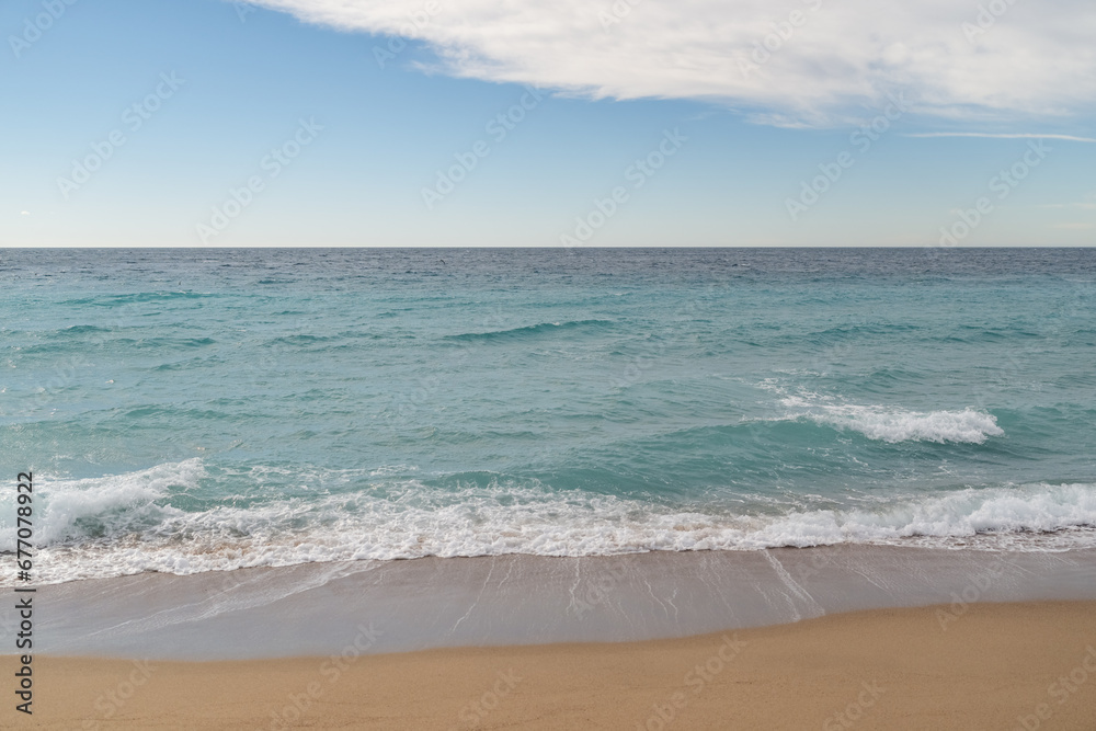 Empty sand beach on Mediterranean sea with horizon line vacation background