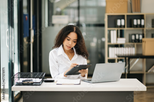 Confident business expert attractive smiling young woman holding digital tablet  .