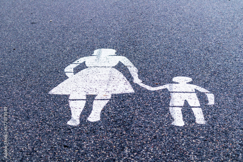 .Pedestrian street sign silhouette woman with child on asphalt photo