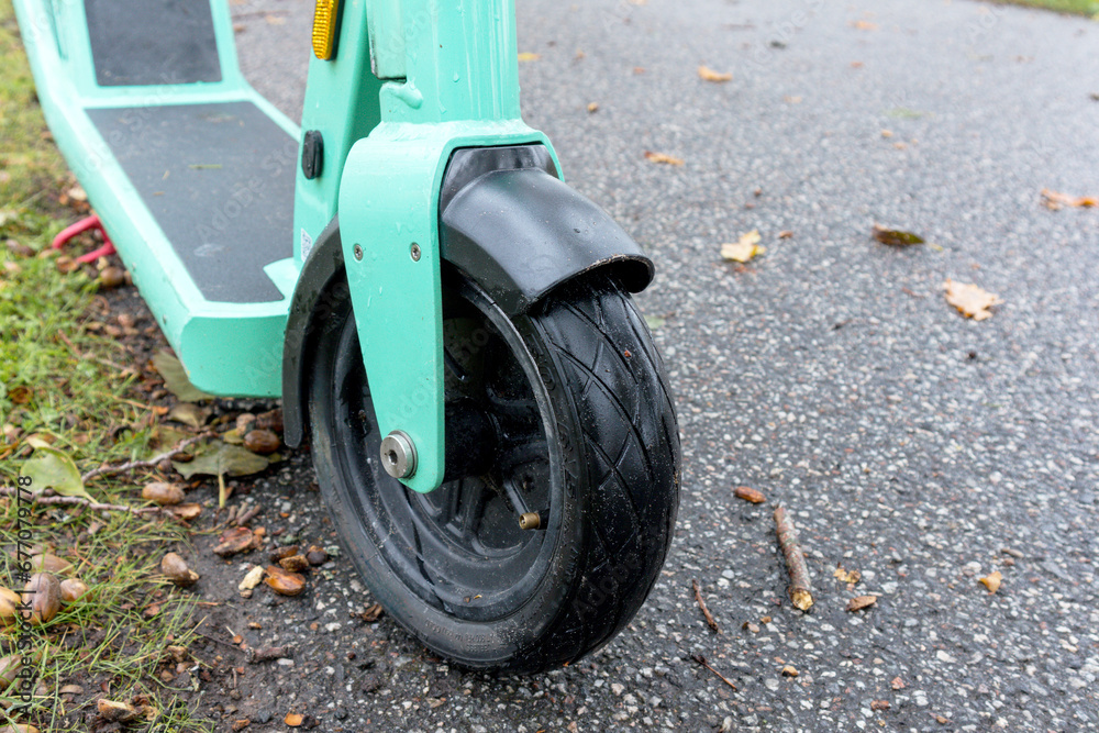 Fototapeta premium .A green colored scooter with a small front wheel