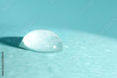 Macro photo of water drop on turquoise background