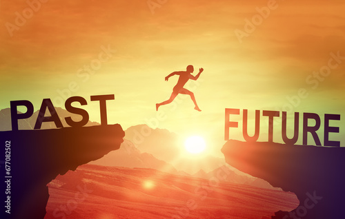 Man jumping on cliff Future. Silhouette man jumping between cliff with Past to Future on sunset background. Goals, hopes and aspirations concept. Leap from past to future photo