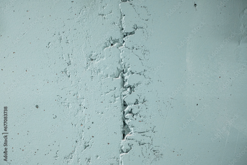 Texture of gray concrete wall with cracks
