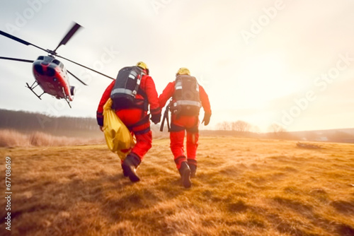 Two paramedics and rescuers in mountaineering equipment run to a helicopter landing photo