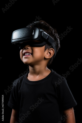 Young boy getting experience using VR headset glasses isolated on a black background © dewaai