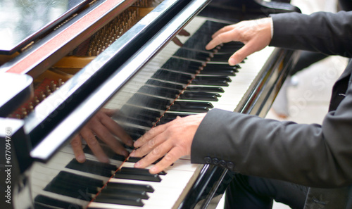 the pianist with his skillful hands touches a melody on the grand piano