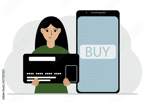 A woman holds a huge credit card next to a smartphone with a Buy button on the screen. The concept of online payments with payment via mobile phone.
