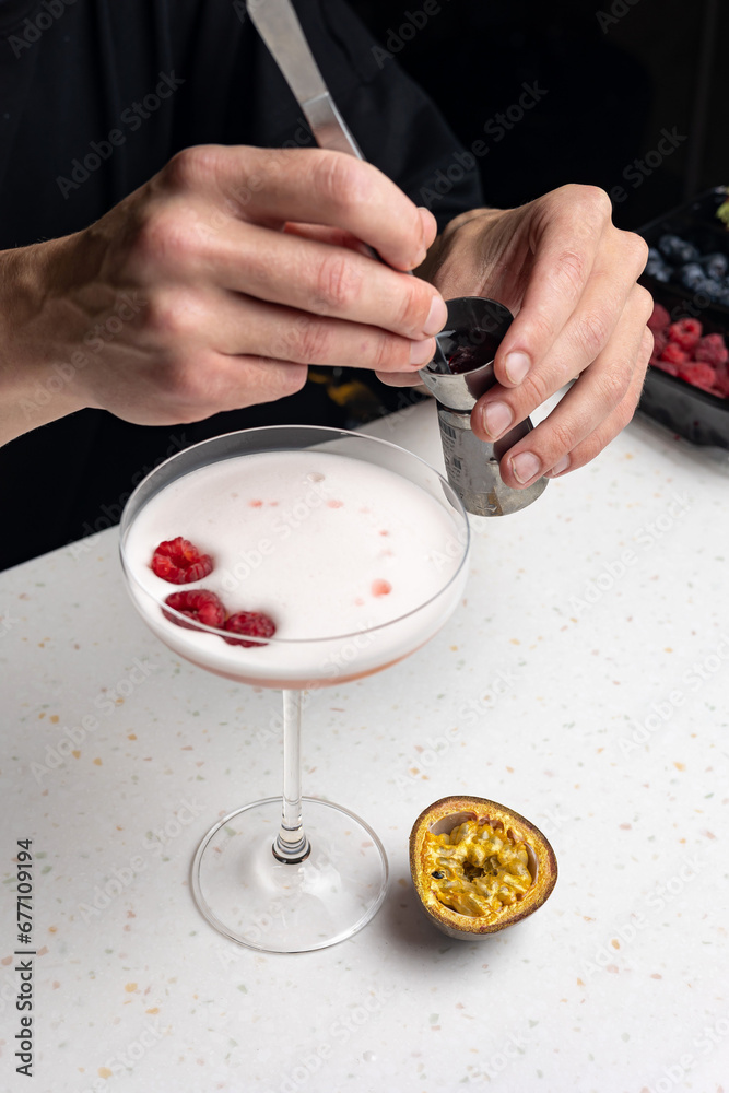 Alcoholic berry cocktail with raspberries 