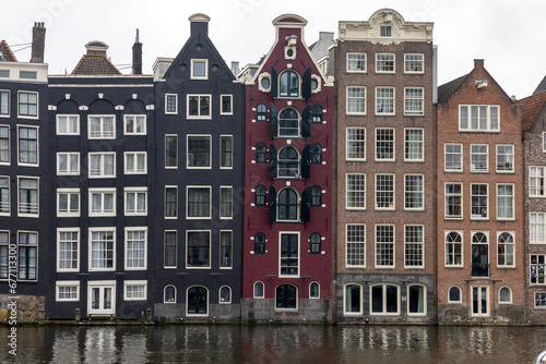 Fototapeta Naklejka Na Ścianę i Meble -  Typical gabled houses on Damrak street in Amsterdam, Holland, Netherlands