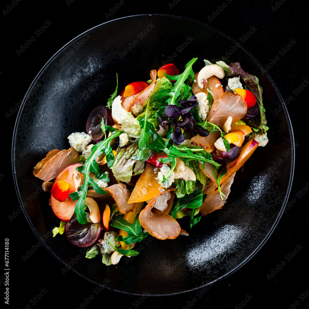 Salad with bacon, persimmon, arugula, olives, blue cheese, cashews and lettuce, dinner. Salad with bacon, persimmon, arugula, olives, blue cheese, cashews and lettuce, dinner.