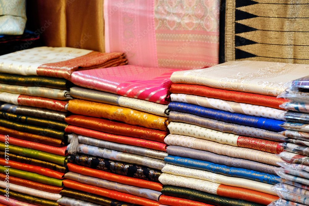 Fancy Indian sarees, Neatly stacked colorful silk saris in racks in a textile shop. Incredible India. Fancy Indian sarees, Neatly stacked colorful silk saris in racks in a textile shop. Incredible India.