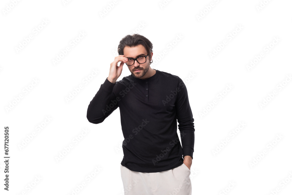 young pensive european guy with stubble and mustache in a black turtleneck and glasses young pensive european guy with stubble and mustache in a black turtleneck and glasses