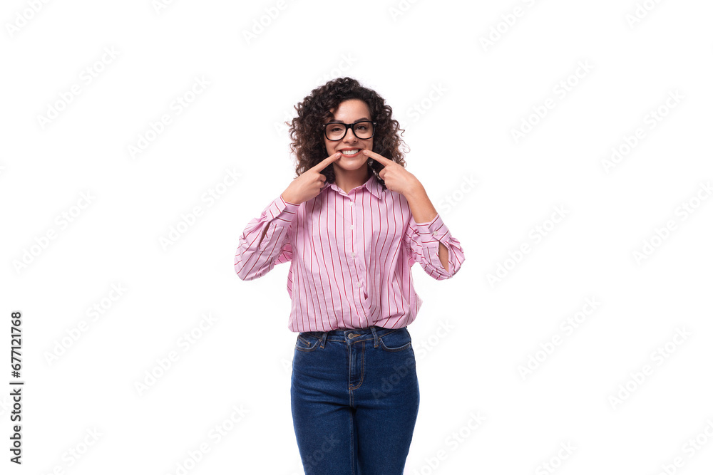 young beautiful curly brunette woman in a pink striped blouse. people lifestyle concept young beautiful curly brunette woman in a pink striped blouse. people lifestyle concept