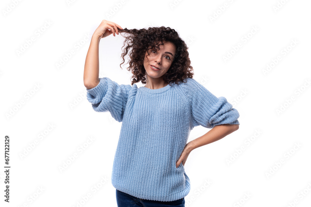 portrait of a young caucasian woman with curly natural dark hair dressed in a casual warm blue jacket portrait of a young caucasian woman with curly natural dark hair dressed in a casual warm blue jacket