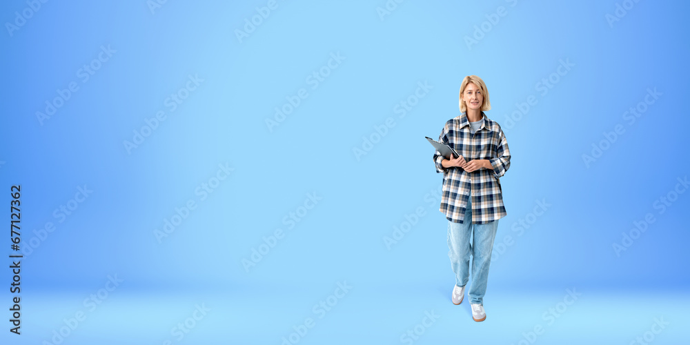 Smiling woman student with folder, full length portrait, blue Smiling woman student with folder, full length portrait, blue