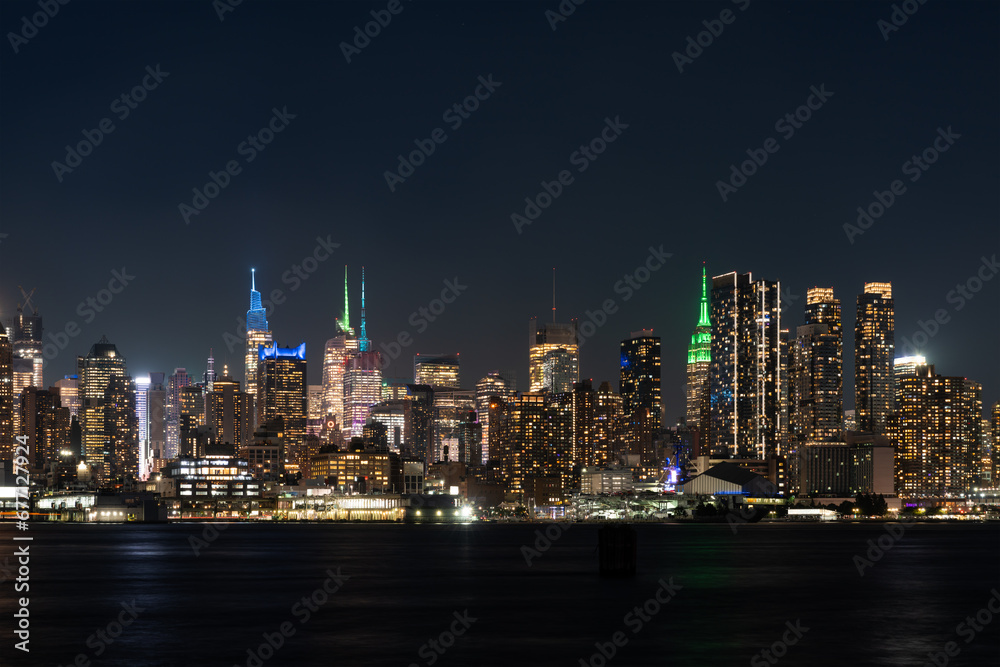 New York Hudson Yards skyline at night with lights, panoramic skyscrapers