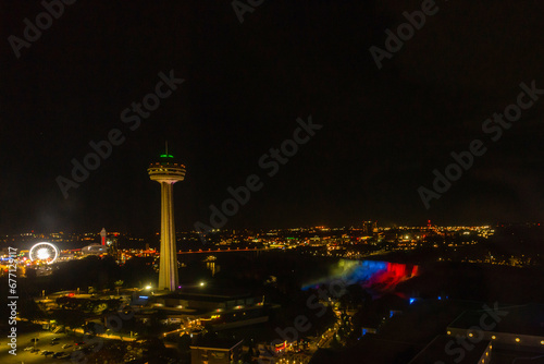 Niagara falls at night with colorful waterfall and the tower