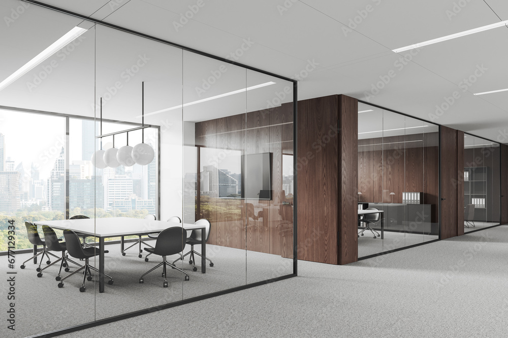 Fototapeta premium Stylish glass office room interior with table and seat, tv screen and window