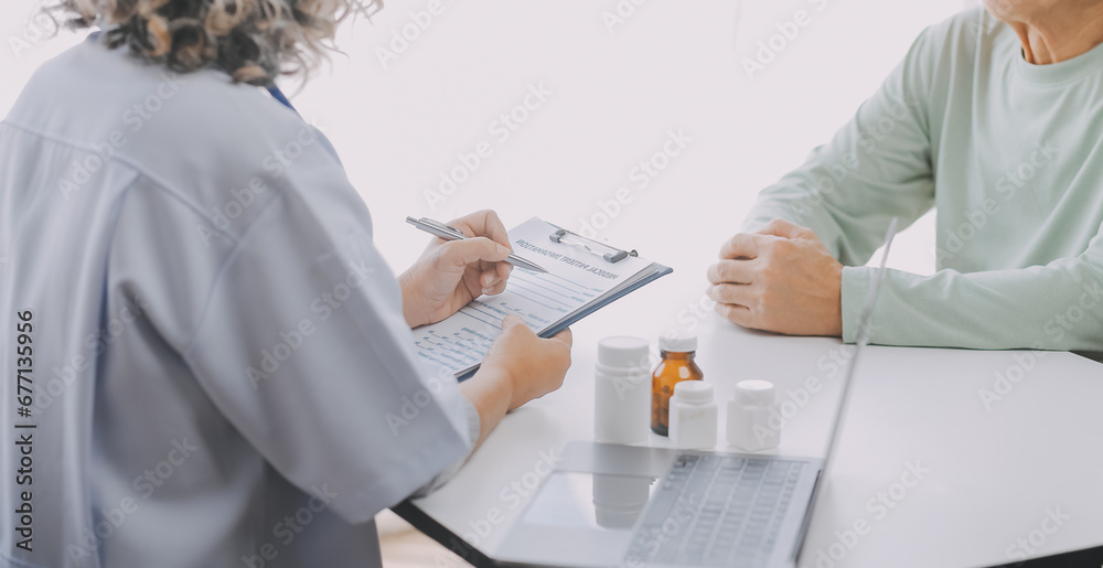 Mature Asian male doctor talking with his patient, explaining the procedure to old lady. Mature Asian male doctor talking with his patient, explaining the procedure to old lady.