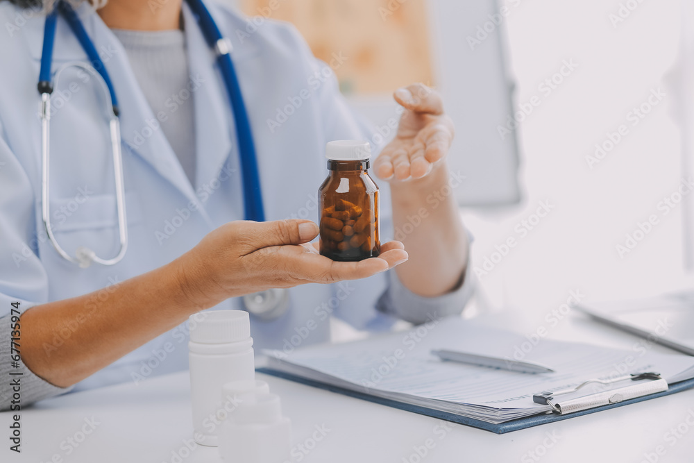 Mature Asian male doctor talking with his patient, explaining the procedure to old lady. Mature Asian male doctor talking with his patient, explaining the procedure to old lady.