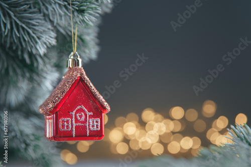 Christmas tree toy in the form of a red house on the Christmas tree