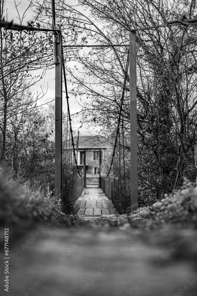 Rural life black and white shallow focus plain photo of a suspended bridge in the Bulgarian village of Debnevo in Northern Bulgaria Rural life black and white shallow focus plain photo of a suspended bridge in the Bulgarian village of Debnevo in Northern Bulgaria