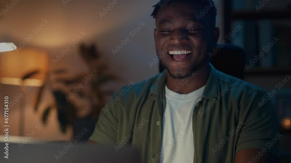 Man making yes gesture during great news on laptop Man making yes gesture during great news on laptop