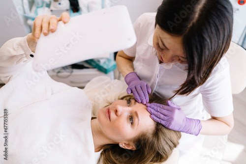 Smiling female client having massage after procedure