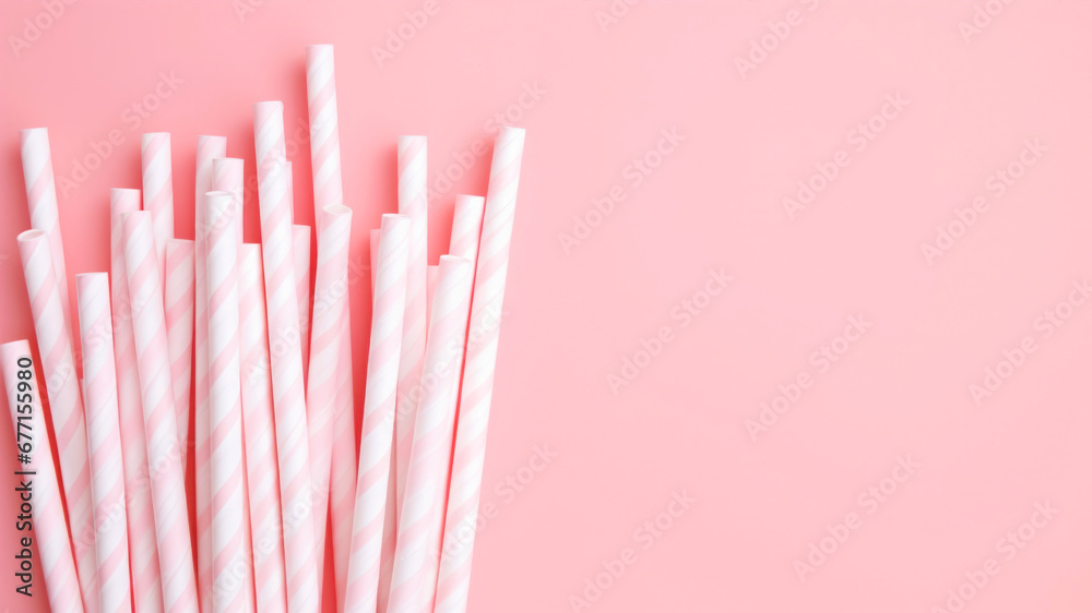 Striped drinking straws on pink background with copy space. Striped drinking straws on pink background with copy space.