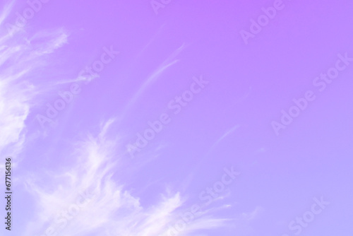 Purple sky with white cloud. Pastel colour backdrop of sunset sky. Beautiful nature. Summer color backgrounds concept. Copy space is on the right. 