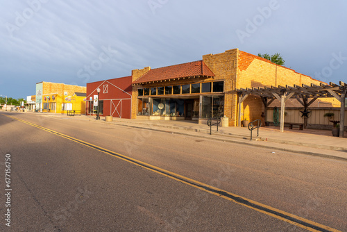A strip of old bricks and wooden buildings along a city street, Quitaque, Texas
