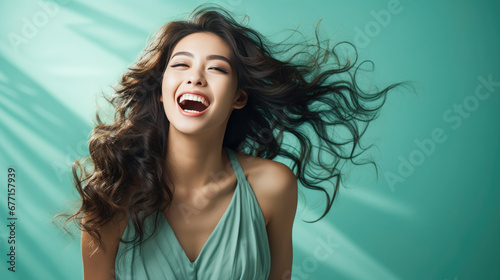 Portrait of vogue fashion smiling Asian girl, soli color background photo