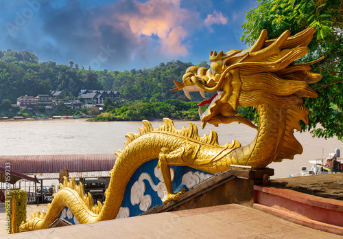 Golden Dragon with wide open mouth wrapped down the Stairs at the Golden Triangle on the Laos Side facing Thailand and Myanmar 