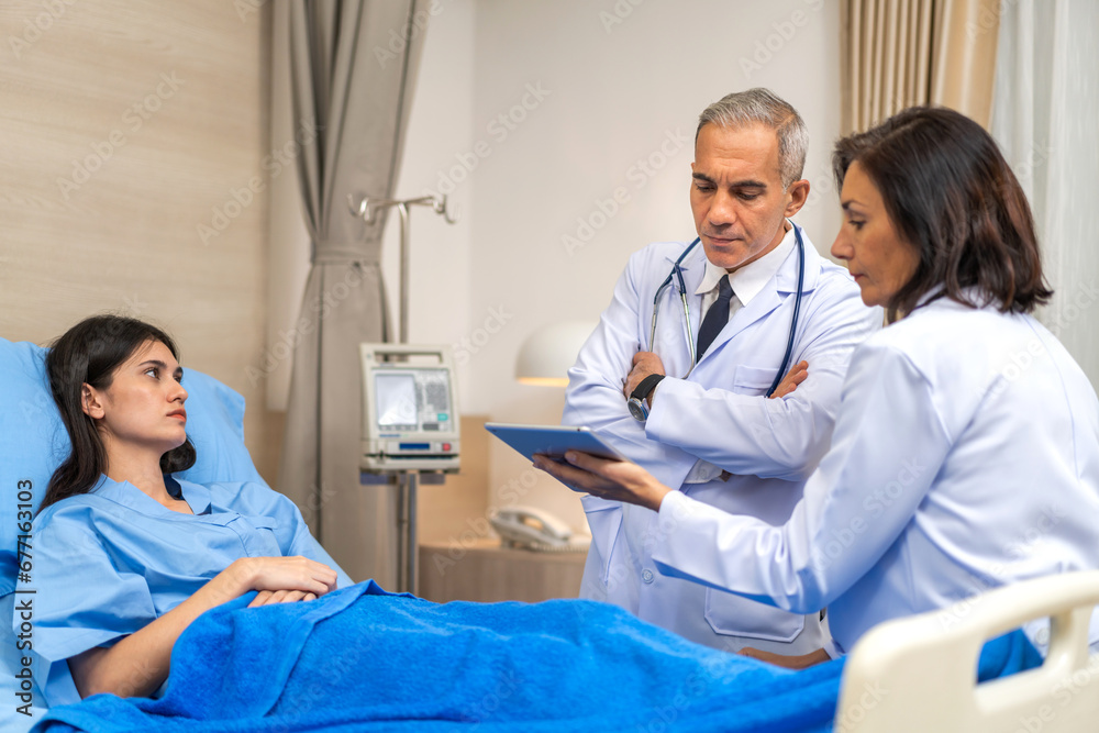 Senior man doctor wearing uniform with stethoscope help discussing and consulting talk to sick woman patient checkup information, support, care, diseases, treatment in hospital.healthcare Senior man doctor wearing uniform with stethoscope help discussing and consulting talk to sick woman patient checkup information, support, care, diseases, treatment in hospital.healthcare