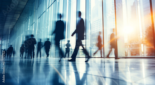 Blurred business people walking fast in the office corridor